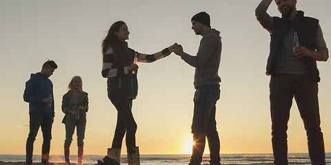 Image showing Friends having fun at beach on autumn day