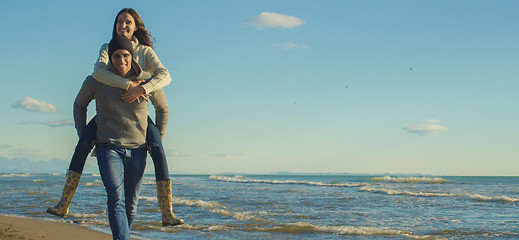 Image showing couple having fun at beach during autumn