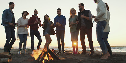 Image showing Friends having fun at beach on autumn day