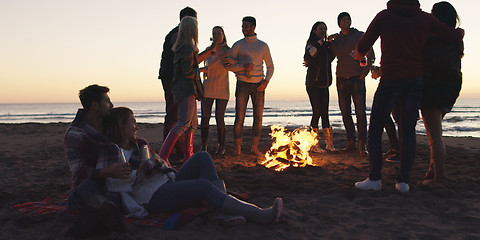 Image showing Friends having fun at beach on autumn day