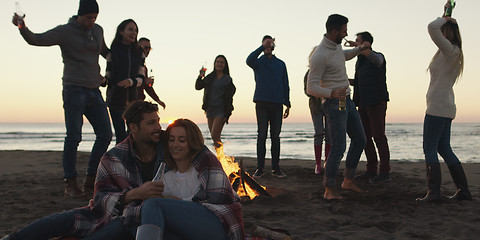 Image showing Friends having fun at beach on autumn day