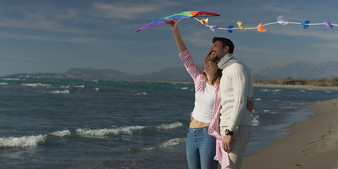 Image showing Happy couple having fun with kite on beach