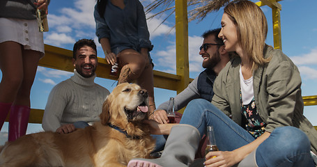 Image showing Group of friends having fun on autumn day at beach