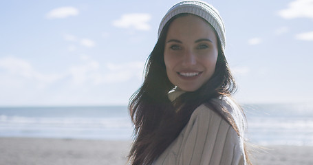 Image showing Girl In Autumn Clothes Smiling on beach