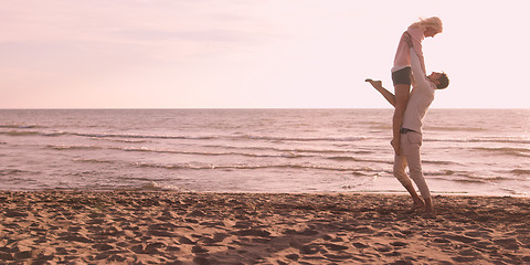 Image showing Loving young couple on a beach at autumn on sunny day