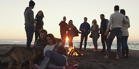 Image showing Friends having fun at beach on autumn day