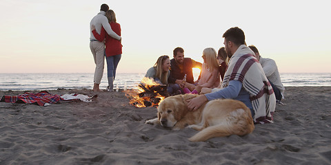 Image showing Friends Relaxing At Bonfire Beach Party