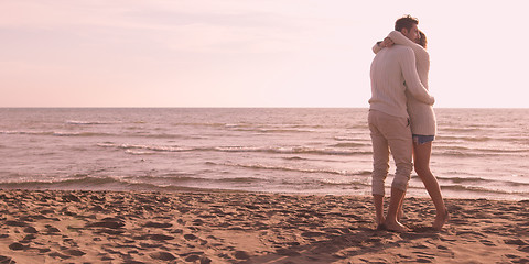 Image showing Loving young couple on a beach at autumn on sunny day