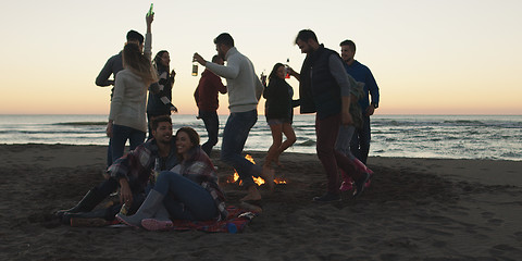 Image showing Friends having fun at beach on autumn day