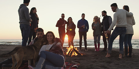 Image showing Friends having fun at beach on autumn day