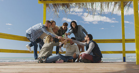 Image showing Group of friends having fun on autumn day at beach