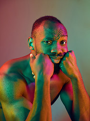 Image showing Close up portrait of a young naked african man looking at camera indoors