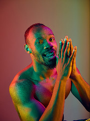 Image showing Close up portrait of a young naked african man looking at camera indoors