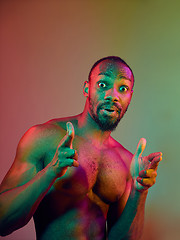 Image showing Close up portrait of a young naked african man looking at camera indoors