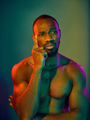 Image showing Close up portrait of a young naked african man looking at camera indoors