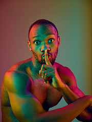 Image showing Close up portrait of a young naked african man looking at camera indoors