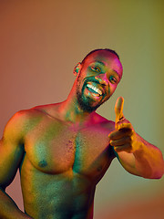 Image showing Close up portrait of a young naked african man looking at camera indoors