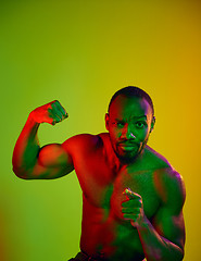 Image showing Close up portrait of a young naked african man looking at camera indoors