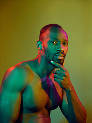 Image showing Close up portrait of a young naked african man looking at camera indoors