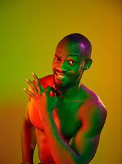 Image showing Close up portrait of a young naked african man looking at camera indoors