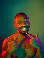 Image showing Close up portrait of a young naked african man looking at camera indoors