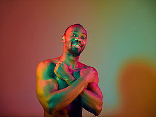 Image showing Close up portrait of a young naked african man looking at camera indoors