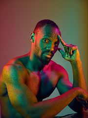 Image showing Close up portrait of a young naked african man looking at camera indoors