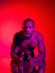 Image showing Close up portrait of a young naked african man looking at camera indoors