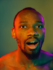 Image showing Close up portrait of a young naked african man looking at camera indoors