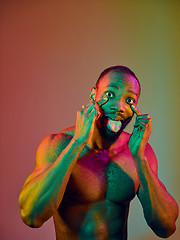 Image showing Close up portrait of a young naked african man looking at camera indoors