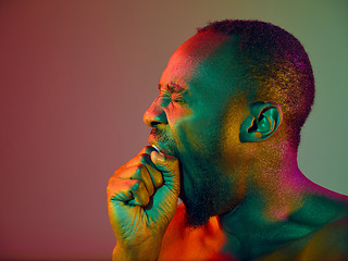 Image showing Close up portrait of a young naked african man looking at camera indoors