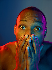 Image showing Close up portrait of a young naked african man looking at camera indoors