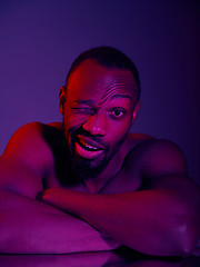 Image showing Close up portrait of a young naked african man looking at camera indoors