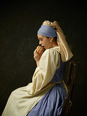 Image showing Medieval Woman in Historical Costume Wearing Corset Dress and Bonnet.