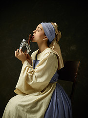 Image showing Medieval Woman in Historical Costume Wearing Corset Dress and Bonnet.