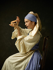 Image showing Medieval Woman in Historical Costume Wearing Corset Dress and Bonnet.