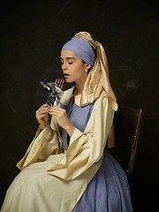 Image showing Medieval Woman in Historical Costume Wearing Corset Dress and Bonnet.