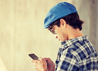 Image showing close up of man texting message on smartphone