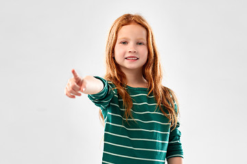 Image showing smiling red haired girl pointing to you