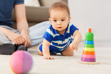 Image showing baby boy with father and pyramid toy at home