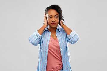 Image showing african american woman closing ears by hands