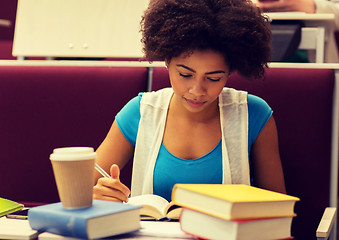 Image showing student girl with books and coffee on lecture