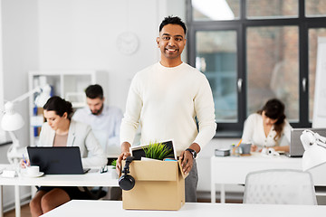 Image showing happy male office worker with personal stuff