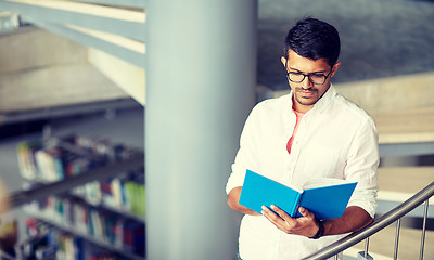 Image showing hindu student boy or man reading book at library