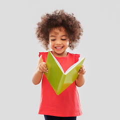 Image showing happy little african american girl reading book