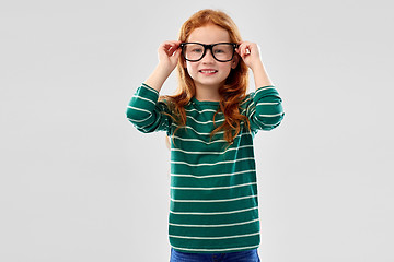 Image showing smiling red haired student girl in glasses