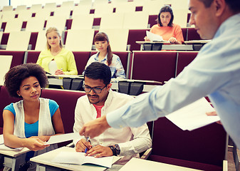 Image showing teacher giving tests to students at lecture