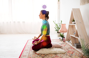 Image showing woman meditating in lotus pose at yoga studio