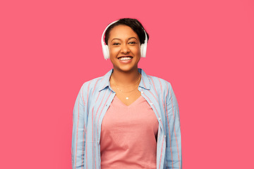 Image showing african woman in headphones listening to music