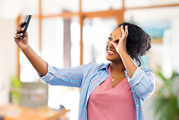 Image showing african american woman taking selfie by smartphone